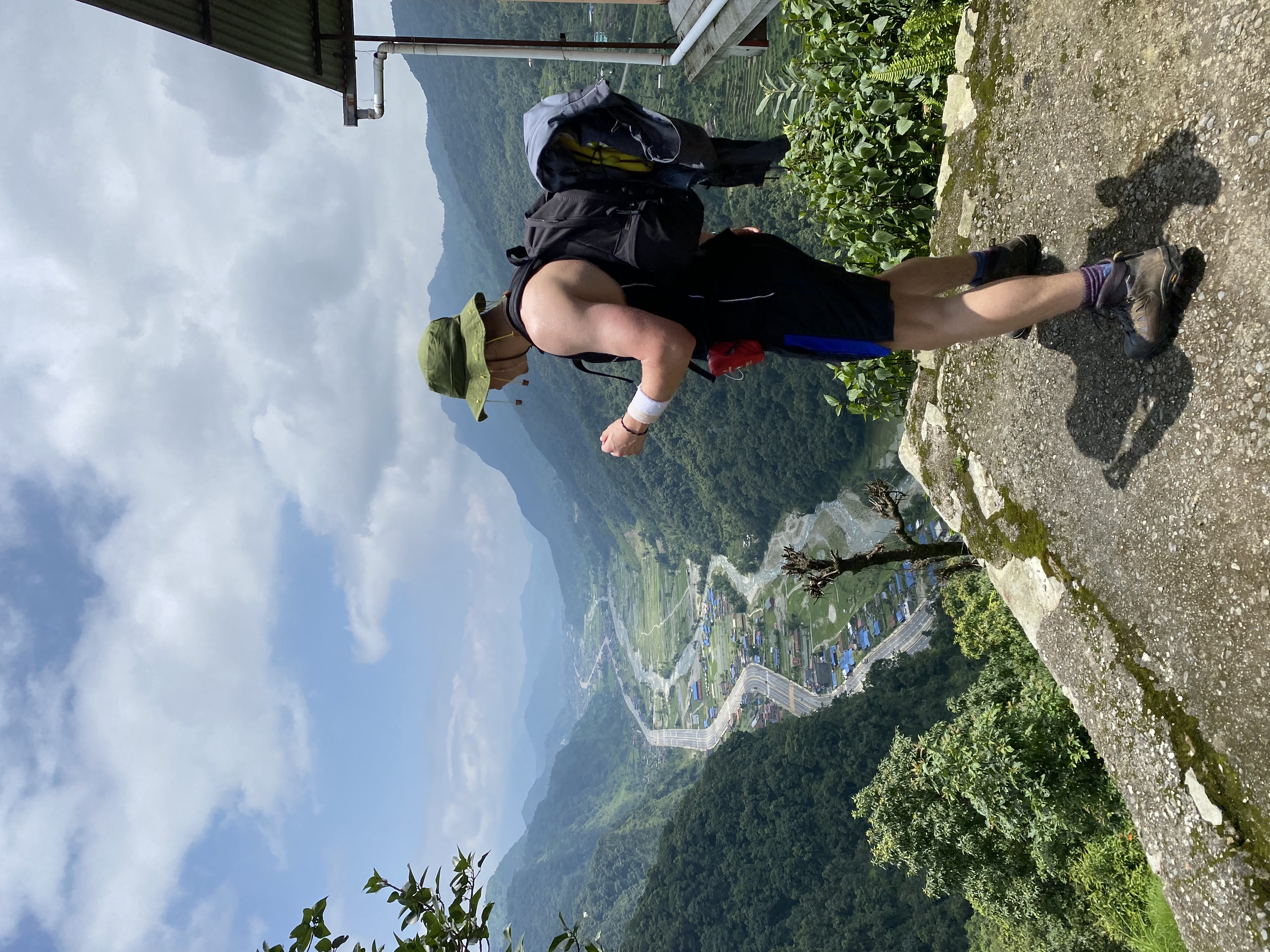 Sam overlooking the Annapurna valley from a high viewpoint, full hiking pack