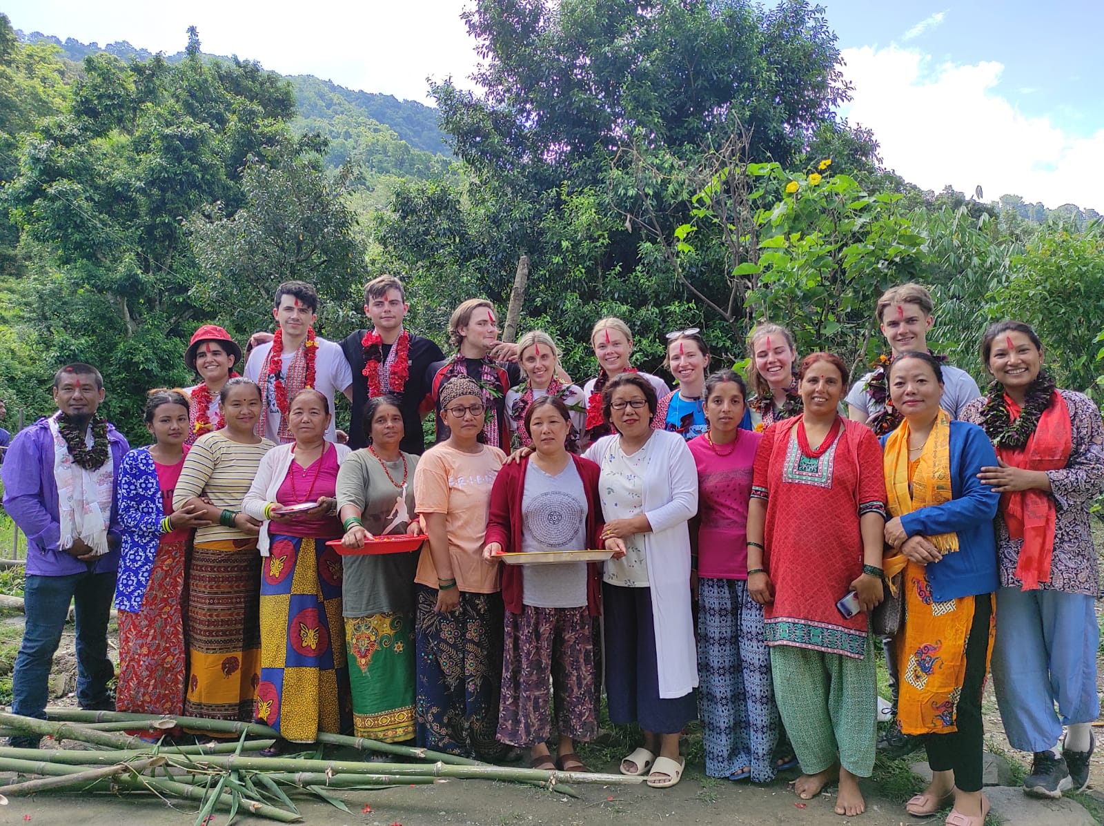 Group photo with local community during welcome ceremony